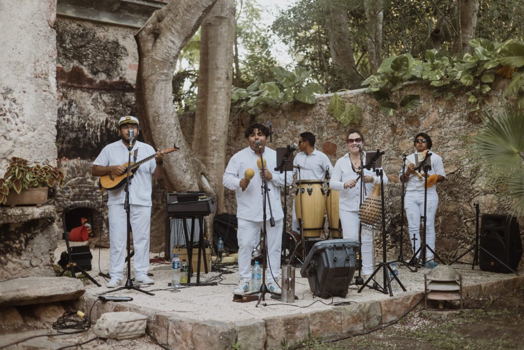 A live band playing in the courtyard of a ruined hacienda building