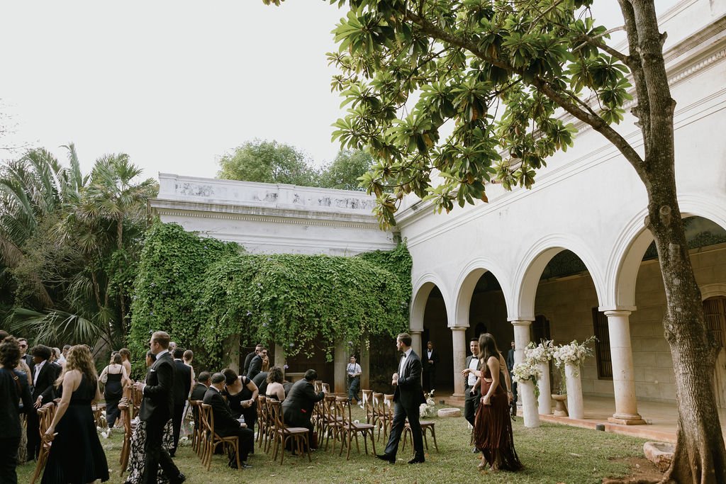 Cocktail hour in a hacienda courtyard beneath an ivy-covered arcade