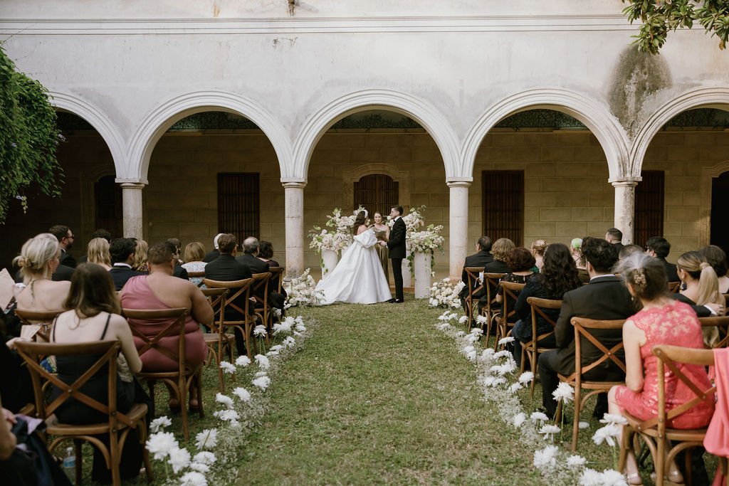 A ceremony under the arches of a hacienda courtyard in Merida