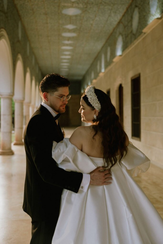 A quiet moment between the couple in the hacienda corridor