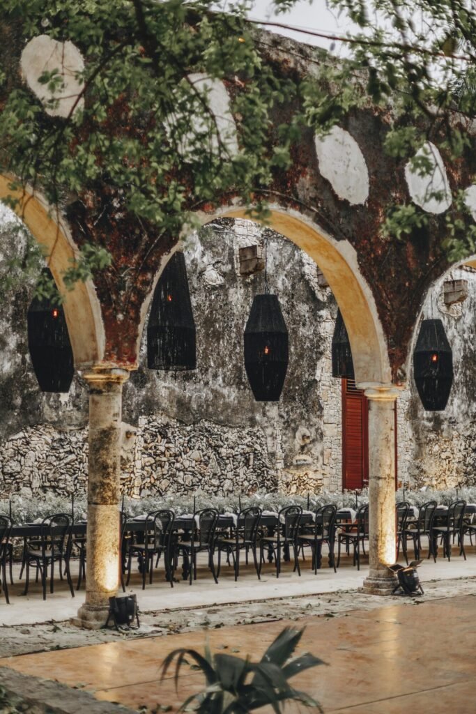 Hanging lamps strung between the arches of the old hall