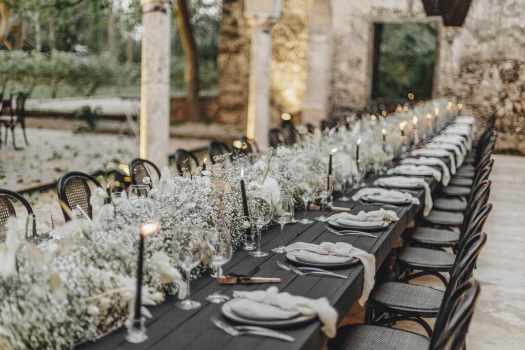 A long table dressed with candles and gypsophila