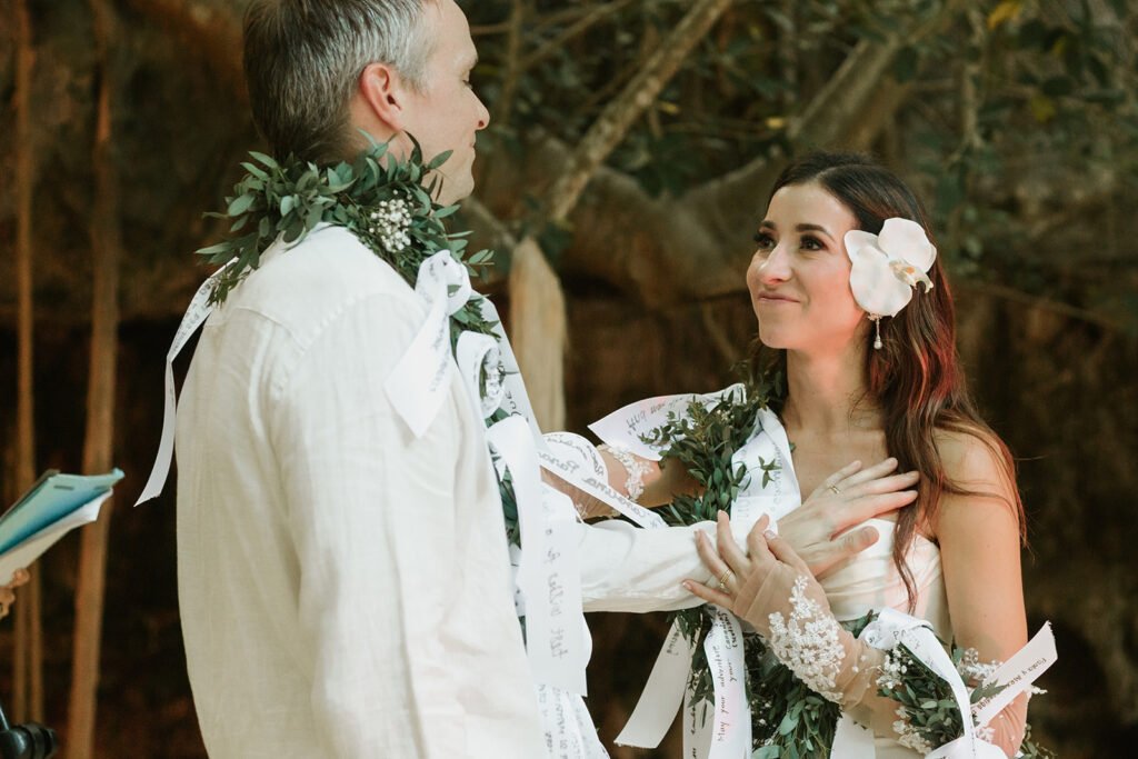 Exchanging vows in the garden wearing flower garlands
