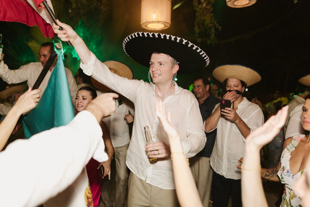 Guests celebrating with sombreros and a mariachi