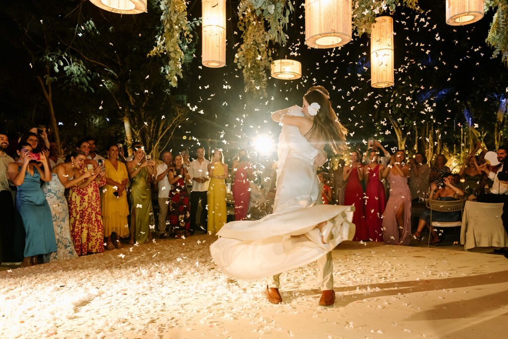 The bride dancing as guests throw confetti
